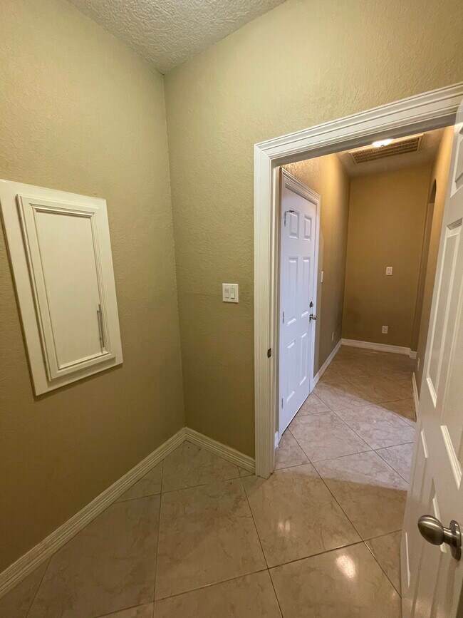 Laundry room with custom wood cabinets gas dryer connection - 600 River Bend Dr