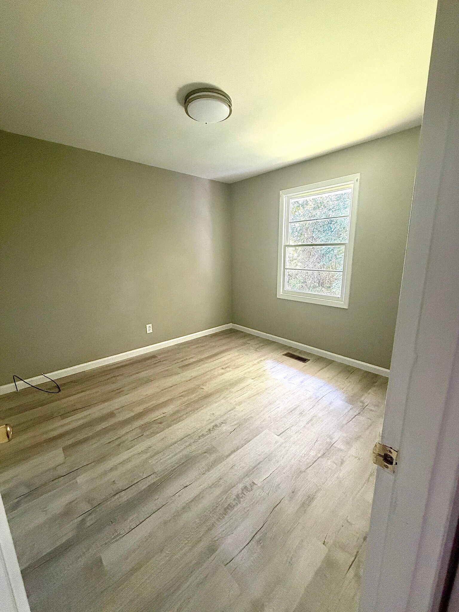 Bedroom 2 - natural light, updated flooring, and a neutral color palette. - 112 Live Oak Dr