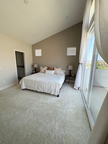 View of primary bedroom with high ceilings and large slider door with views of surrounding fam park - 2241 Horseback Rd