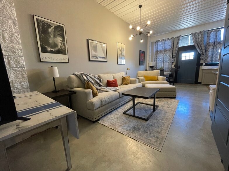 Living area with lighting and front door and windows. - 475 S Hickory St