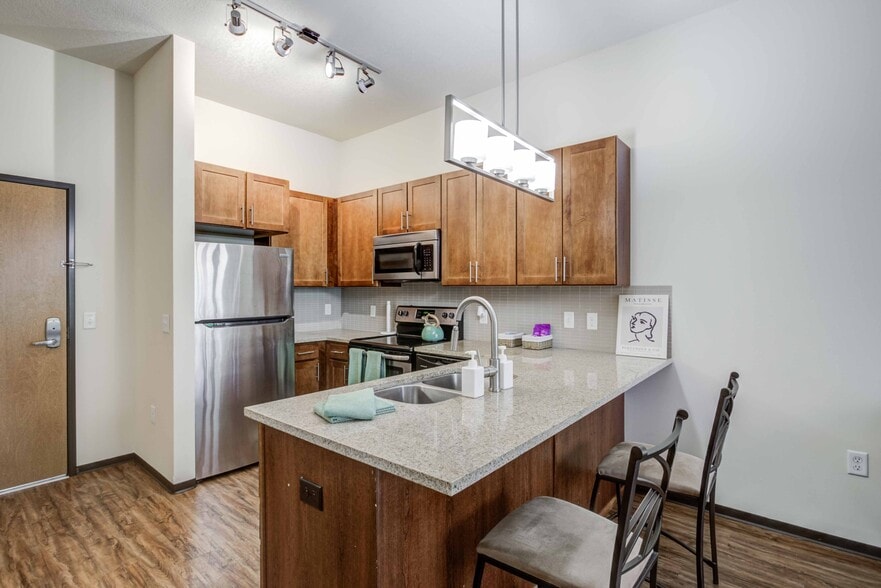 The-Knoll-Dinkytown-Off-Campus-Apartments-Near-The-University-of-Minnesota-Kitchen-with-Extra-Wide-Kitchen-Islands-Bar-Stool-Seating-Granite-Countertops - The Knoll Dinkytown