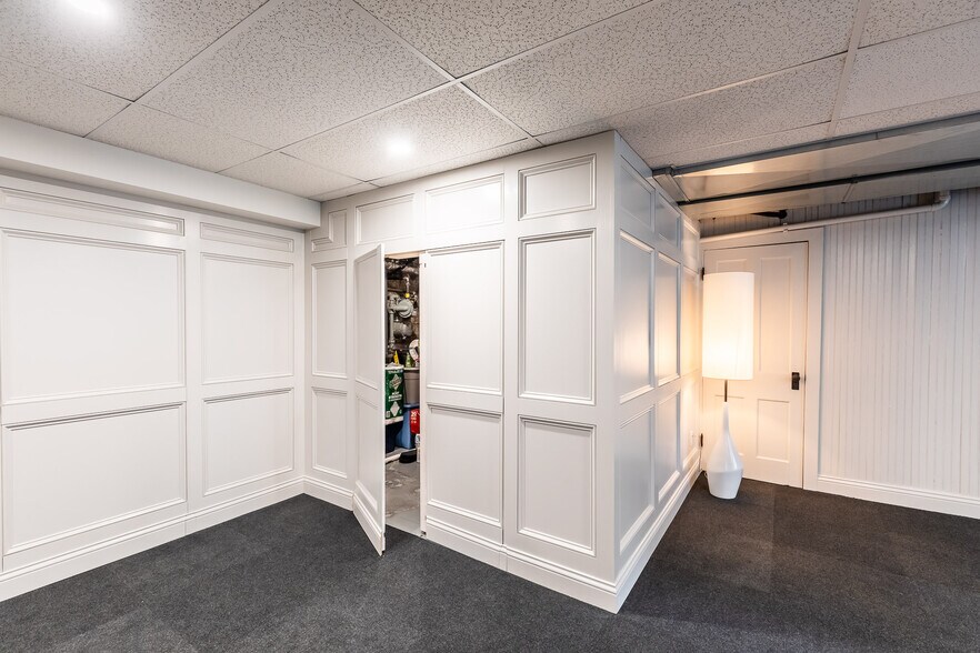 Custom Paneled walls are hidden storage areas. - 4061 Beechwood Ave