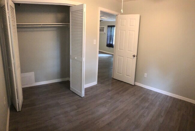 Bedroom 2 with ceiling fan and window A/C unit - 9803 N Aster Ave