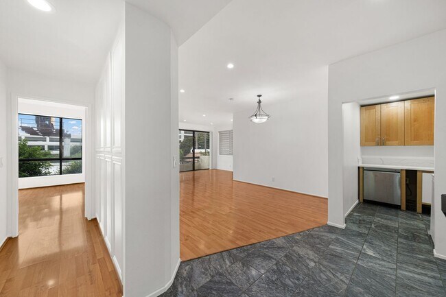 Hall view - separate the en-suites, view of living room & floor to ceiling storage - 1745 S Bentley Ave