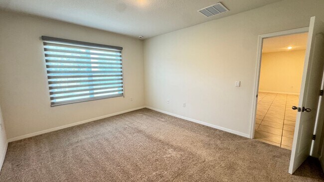 Building Photo - Available NOW! Spacious 4BD/2BA Haven in Villages at Harmony – Your Dream Home Awaits! WASHER & D...