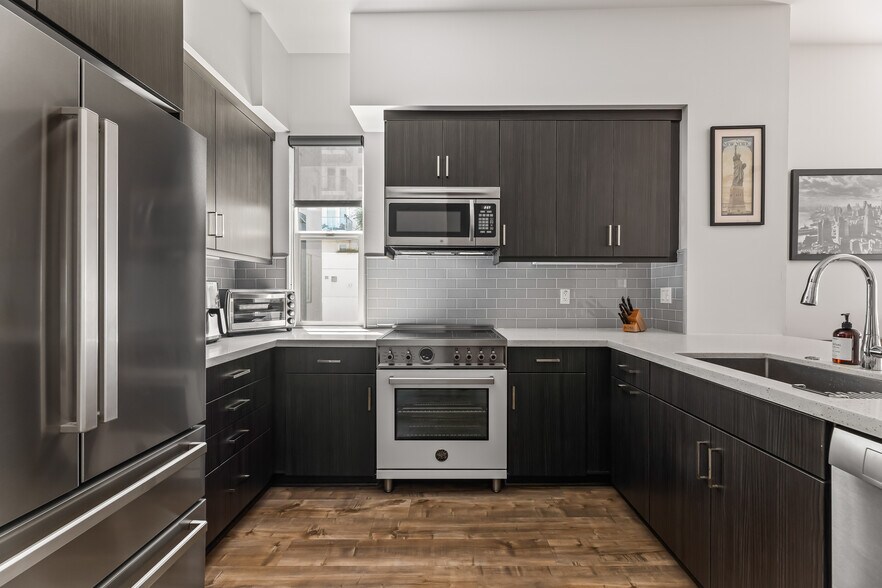 Kitchen featuring Bertazzoni 30" induction free standing range, microwave, fridge, Bosch dishwasher - 215 Elm Ave