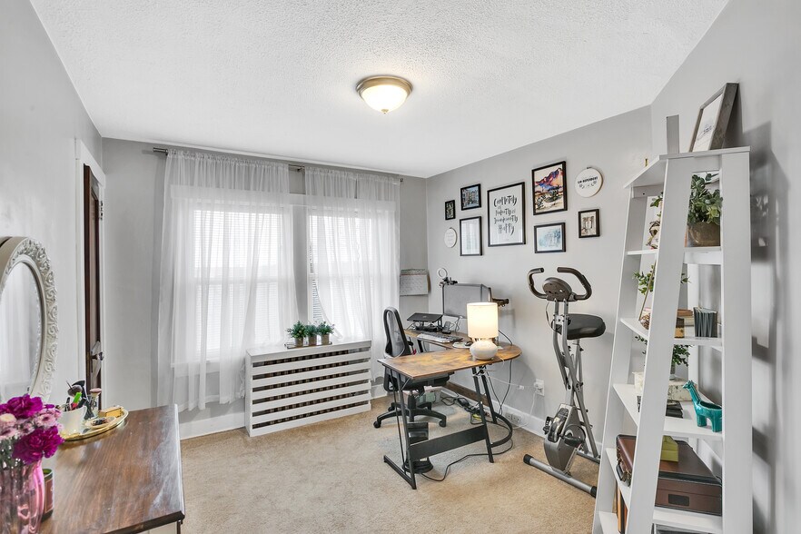 Third bedroom currently used as a home office, showcasing the flexibility of the floor plan. - 203 Richbarn