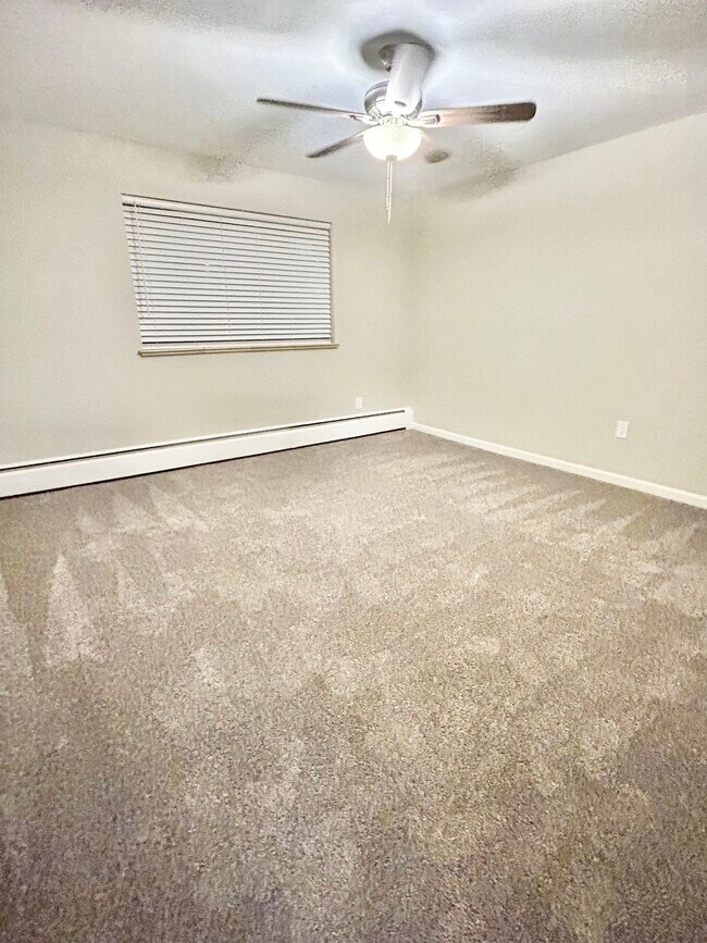 Experience comfort in this airy bedroom, perfect for restful nights. - GRACE LANDINGS APARTMENTS