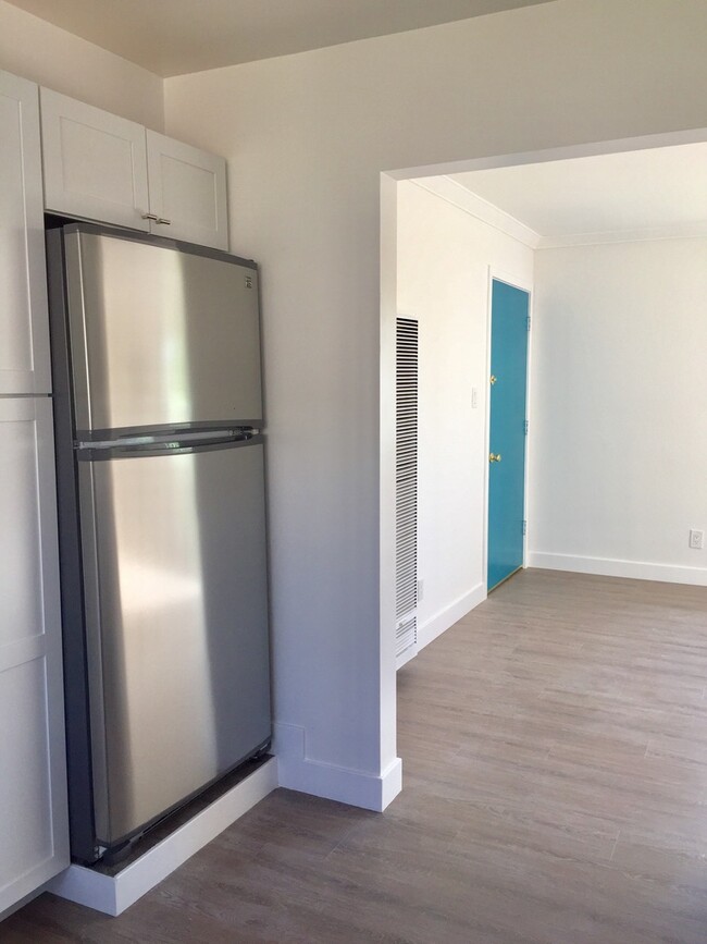 this is part of the kitchen and looking towards the front door - 110 S Grand Oaks Ave