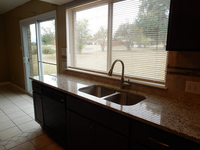 Huge Kitchen window to watch kiddos play - 12307 shadyview dr