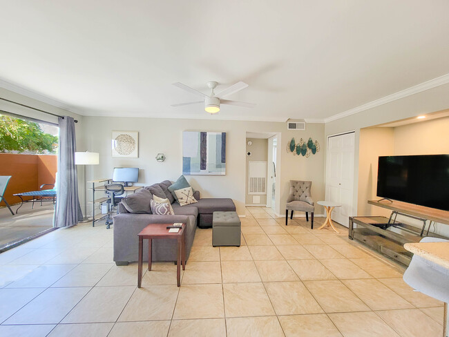 Inside the large living area, you'll be able to enjoy a cup of coffee or tea or work at the desk! - 3500 N Hayden Rd