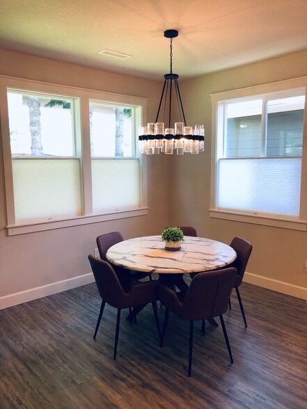 Dining room with designer lighting. Open to living room and kitchen for optimal entertaining. - 12048 NE 109th St