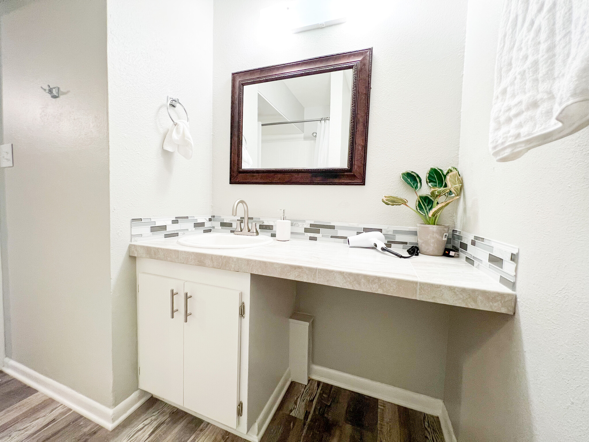 Luxury awaits in this renovated bathroom with tile finishes and new sink. - 2125 Banita St