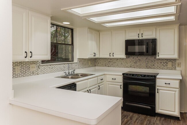 Building Photo - Charming 2-Bedroom Condo in Gated Community Surrounded by Mature Trees