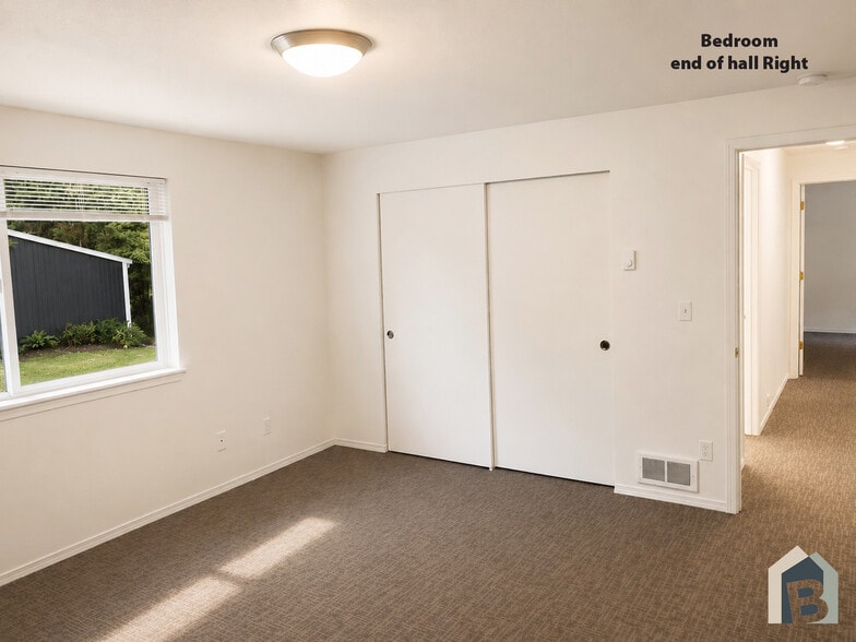 2nd floor large bedroom with view of lawn and mature evergreen trees and double closet - 20981 Port Gamble Rd NE