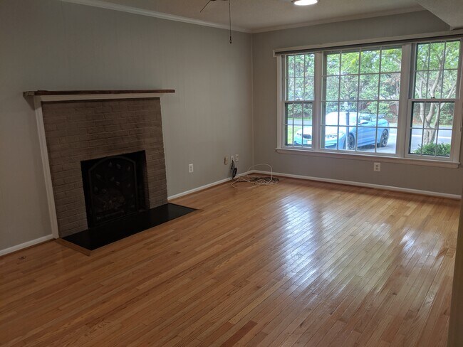 Family room with fireplace and large windows - 46675 Winchester Dr