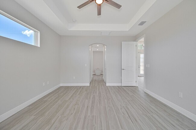 Building Photo - NOW AVAILABLE - Gorgeous Pool Home ~ NW Cape ~ 3 Car Garage ~ On Canal!
