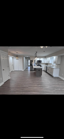 Open floor downstairs with living room and dining area - 713 E Powell Ave