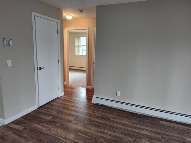 View from living room showing new flooring, paint, baseboard, outlets, and switches - 9 Kenmar Dr