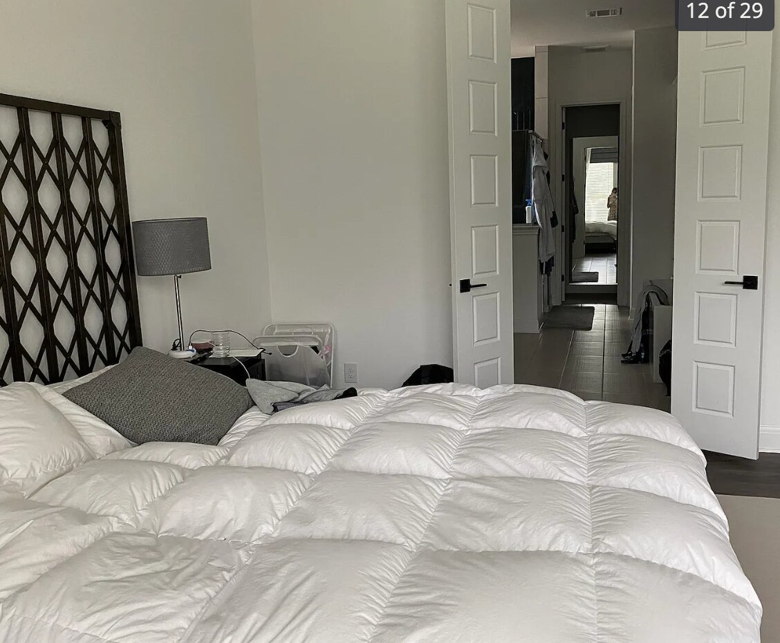 Primary bedroom with double door access to large bath - 24719 Resort Pky