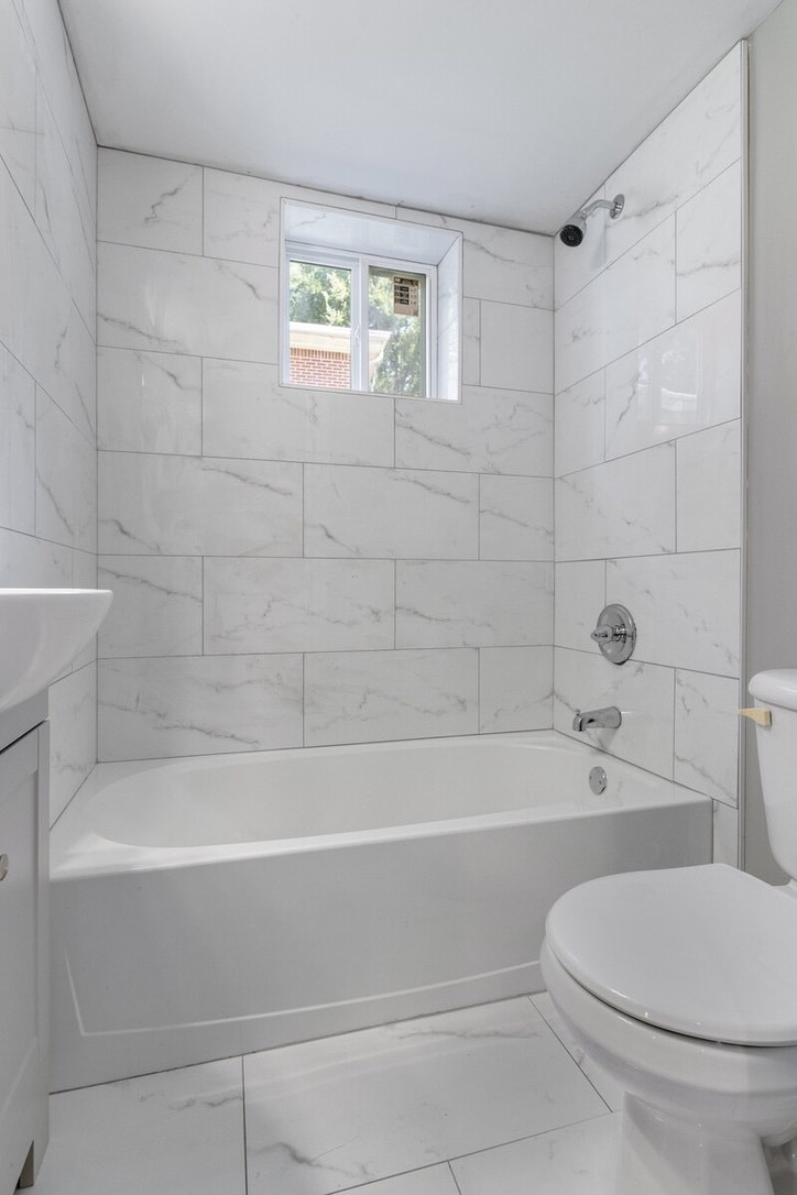 Bathroom includes floor-to-ceiling tiles - 2058 Nettie Ct