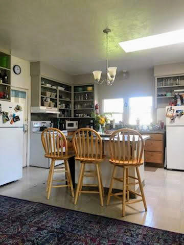 Kitchen - includes BI dishwasher, two refrigerators, three swivel bar chairs, and lots of storage. The laundry room is located through the left-side door between the range and refrigerator. Check out the skylight (: - 804 NW 29th St