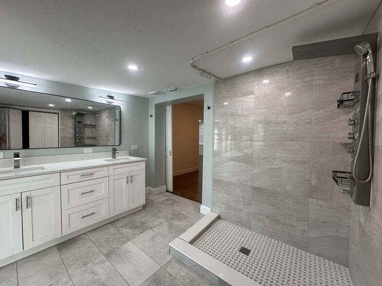 master bathroom with double sinks and spa shower - 5932 McKee Lake Dr N