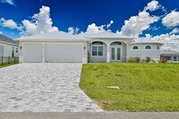 Building Photo - NOW AVAILABLE - Gorgeous Pool Home ~ NW Cape ~ 3 Car Garage ~ On Canal!
