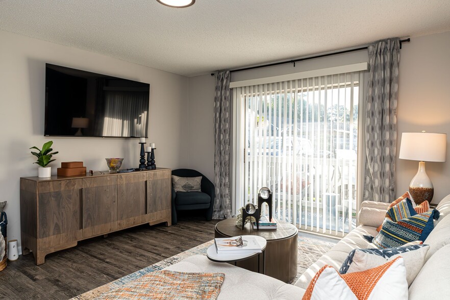 Spacious living room with hardwood-style flooring - The Linden Apartment Homes