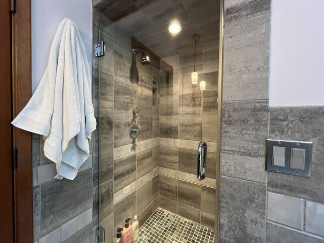 Building Photo - One-of-a-Kind Custom Home with Wall of Windows, Stone Fireplaces, Expansive Entertainment Space &...