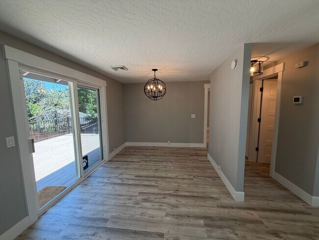 Building Photo - Spacious 4BR/3BA Home with Deck, Fenced Yard & Garage