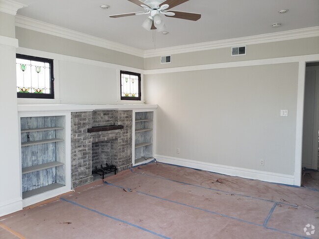 Living room with fireplace and bookshelf - 3811 N Central Park Ave