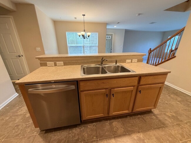 Building Photo - LEASING SPECIAL! Bright Open-Concept Condo with 1-Car Garage in Prime Commuter Location