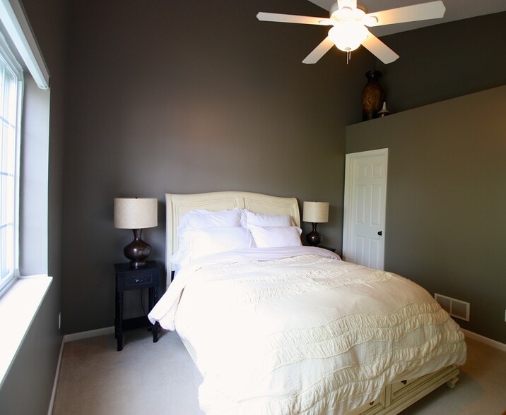 Master bedroom has a valved ceiling, remote control ceiling fan, and black out shade. - 15805 24th Ave N.