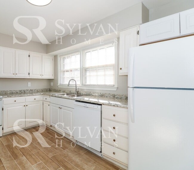 Building Photo - Venture outside to the expansive backyard,...