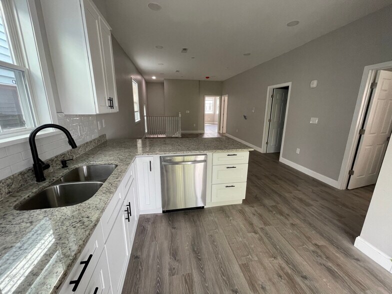 Unit two: brand new open-concept kitchen (all-new appliances, cabinets, granite countertops with mod - 34 Falcon St