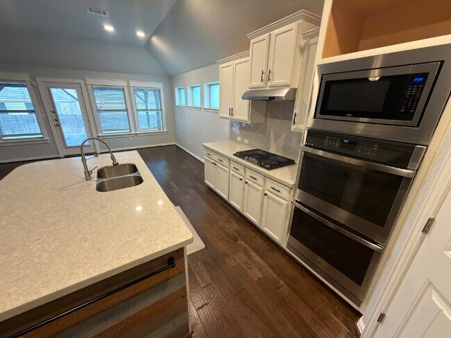 Building Photo - Four bed two bath on a corner lot with a pool in Sunfield. Gas cook top, double ovens. Open kitch...