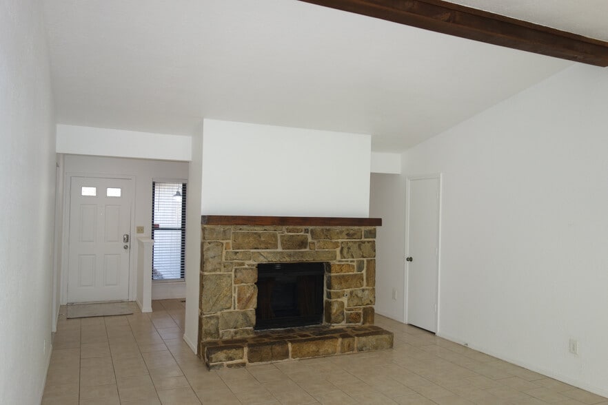 View of the living room. Entry door on Left and Coat Closet door on right - 6604 S Utica Pl