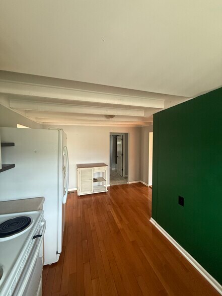 Kitchen with moveable island. Ample space to add cabinet for pantry - 1624 Porter Ave