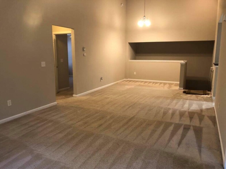 Other side of Living/dining area showing going downstairs, left door entrance to 2nd and 3 - 13800 Herons Landing Way