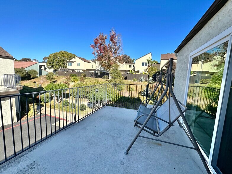 The sliding door leads to a balcony that can fit a 2-3 person swing and a 4-person patio set. - 9505 Easter Way
