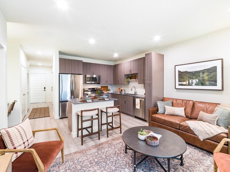 An open-concept apartment home at Modera University Park, where kitchen, dining, and living spaces come together for effortless everyday living. - Modera University Park