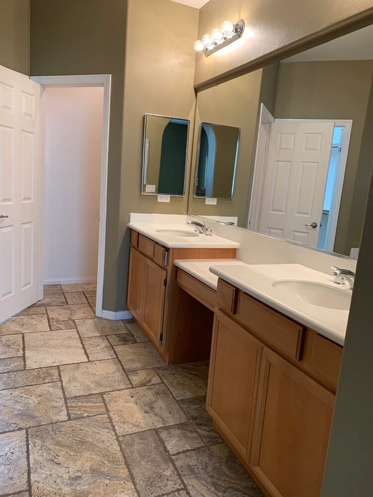 Primary bedroom bathroom. Double sinks and walk-in-closet. This is on the first floor. Three other bedrooms are upstairs. - 84126 Canzone Dr