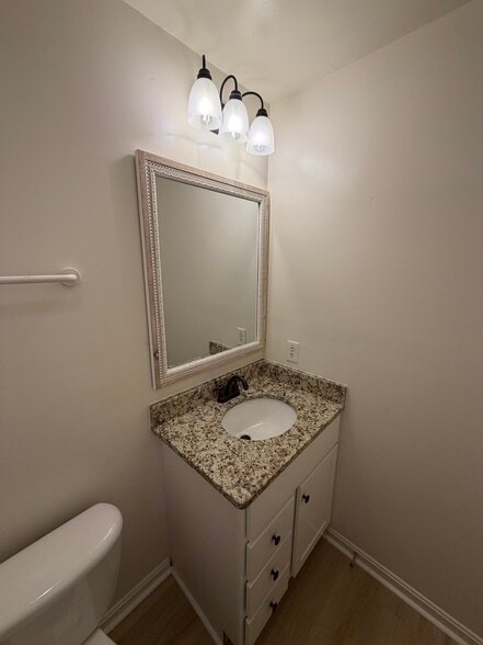 1/2 bath with new vanity, granite countertops add sophistication - 903 Harwood Rd