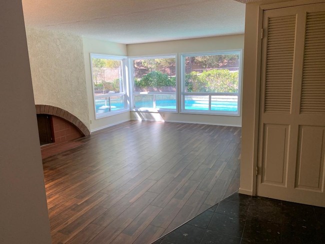 Living Room with view of pool. Window treatments added after photo - 2571 Cordelia Rd