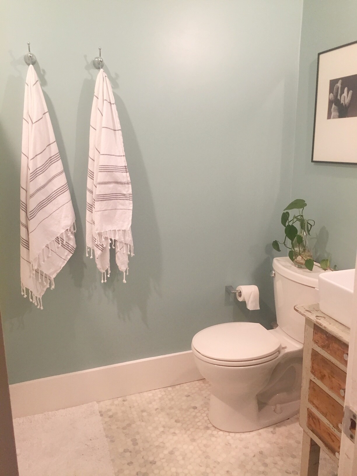 Bathroom has hexagon marble floors and vintage vanity with vessel sink. - 1003 Egan St