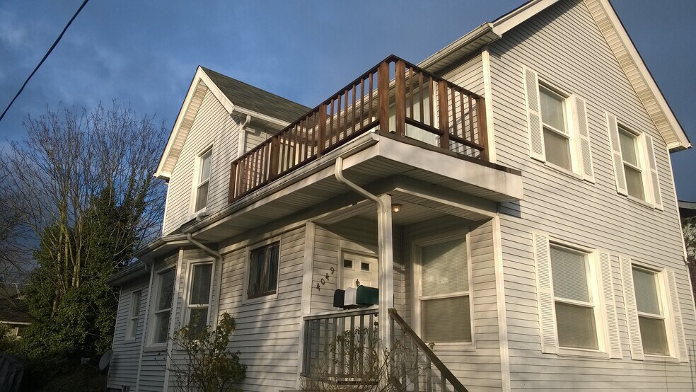 Exterior view of upper unit prior to newly painted deck - 4049 Latona Avenue NE