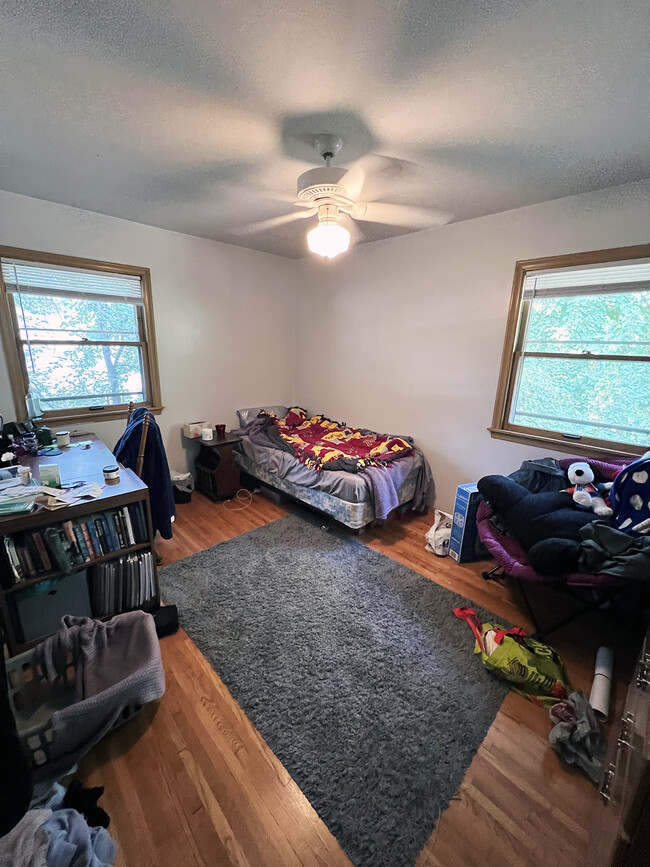 Main floor bedroom with ceiling fan. - 1911 Talmage Ave SE