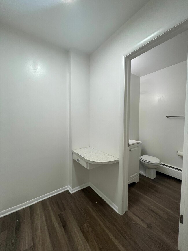 Explore the charming corner leading to a modern bathroom. - GRACE LANDINGS APARTMENTS