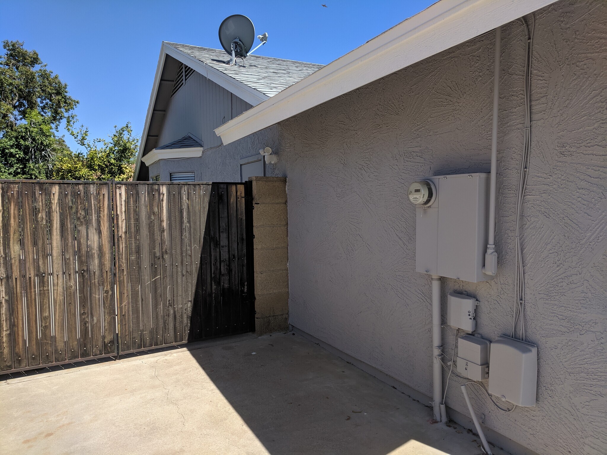 North side of garage with electric panel and motion sensor security light at top of wall. RV Gate to back yard. - 14101 N 78th Dr